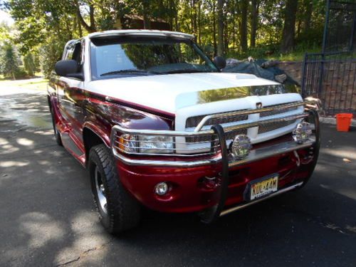 Bright white with custom red paint/striping, mist gray interior, chrome grilles