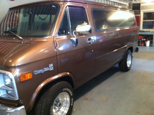 Tan chevy van excellent for utility use, set up with shelves throughout