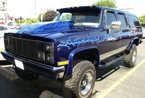 1986 air brushed pearl blue suburban reborn as a lifted custom hot rod truck