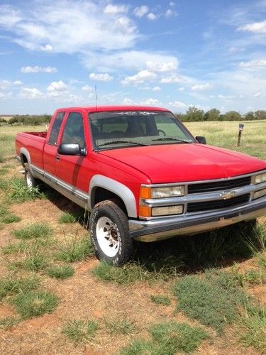 97 red and silver chevy silverado 3/4 ton 4x4 long bed extended cab