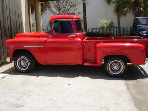 1955  red chevy pickup truck, short bed, big back window,