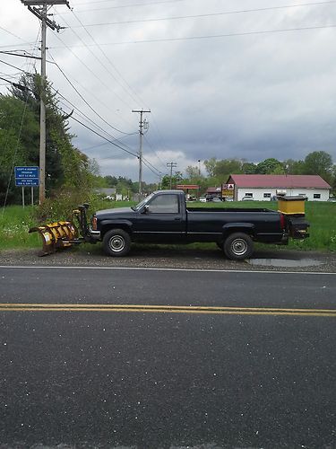 Black pickup with snow plow and sander
