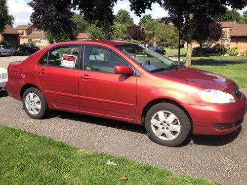 Toyoa corolla 2006 le  low miles.  red.  2nd owner