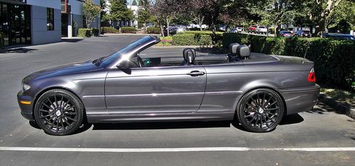 Grey convertible with black top and black 19in wheels.
