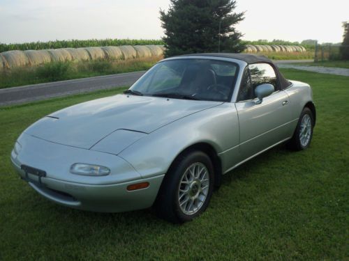 Silver, good condition, 2 door, black convertible top, after market wheels,