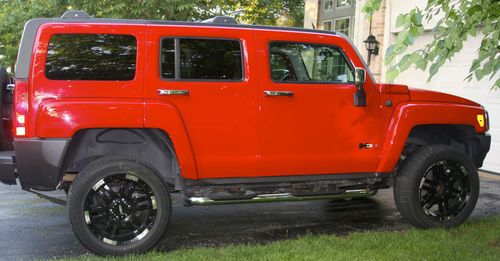'06 red hummer h3 with black rims and sound system