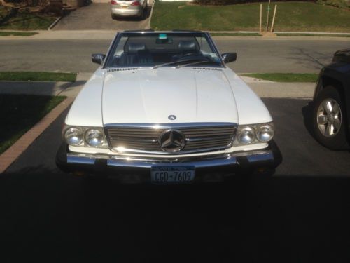 1988 mercedes benz 560 sl in white with blue top convertible.