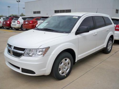 White 2014 dodge journey se with extra row seating.