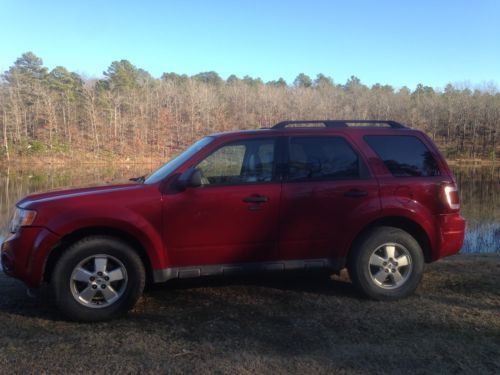 Red 2009 ford escape. awd, leather seat covers, tow package