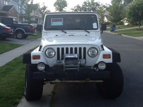 99 white jeep wrangler with 31" tire a 6" rubicon extreme lift locked front rear