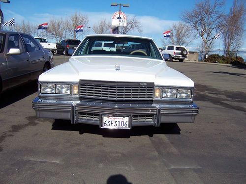 A nice white 1977  cadillac deville 4 doors