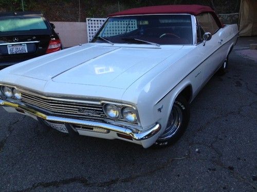 1966 chevrolet impala convertible white exterior with red interior.