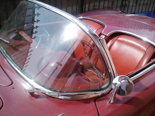 V-8 automatic, leather interior good looker red on red with a 1958 hood