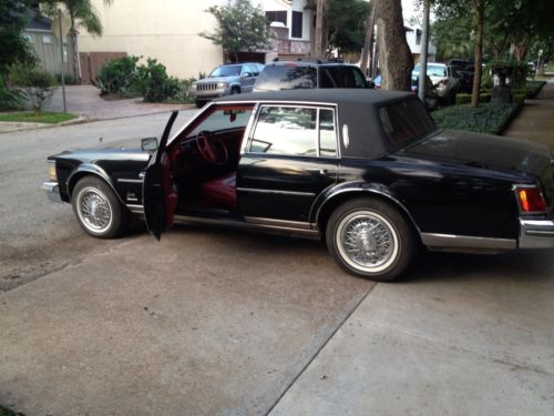 Cadillac seville 1978 with 85,000 orig. miles black w/red leather interior