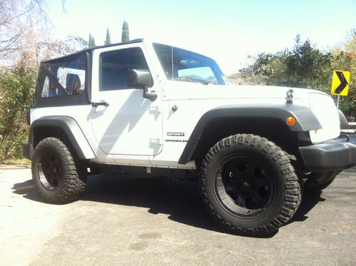 2011 bright white jeep wrangler sport 2-door 3.8l with aftermarket wheels.