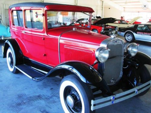 Red and black ford model a 1930 with tan interior