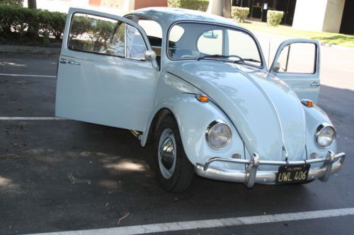 1967 light blue restored volkswagon beetle