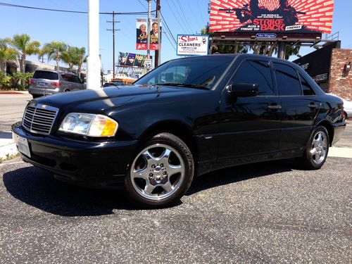 Sporty mercedes -benz c-280 black on black chrome rims