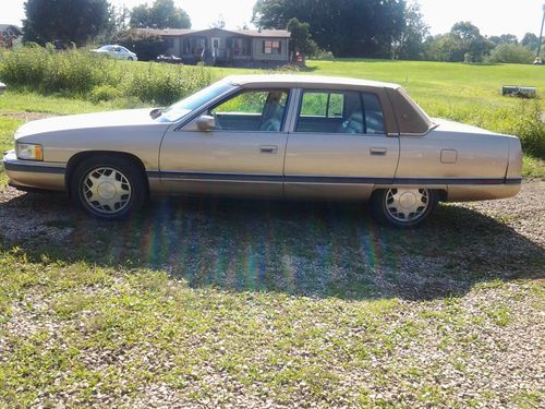 Gold/beige cadillac deville with vinyl top 4 door great gas mileage,cold ac