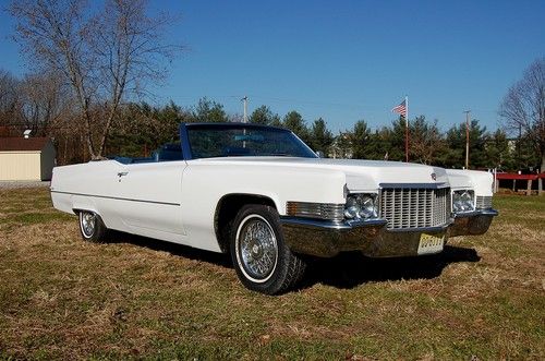 Must sell  restored 1970 cadillac deville convertible, new top, wire hub caps..