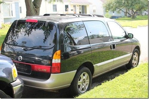 2001 black and silver used minivan with tan leather seats