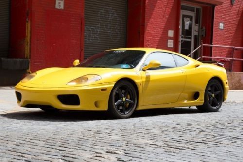 2004 ferrari 360 modena f-1  in yellow with a black interior