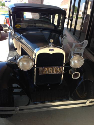 1930 ford model. a   4 door with suicide factory doors.  original car