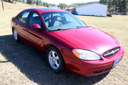2003 ford taurus red $1650 very good on gas reliable v6