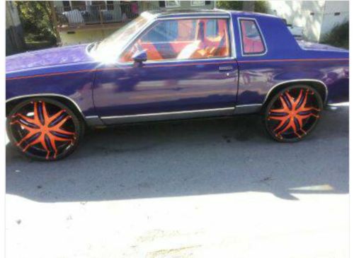 1986 cutlass gbody t -top on 24s purple and orange.
