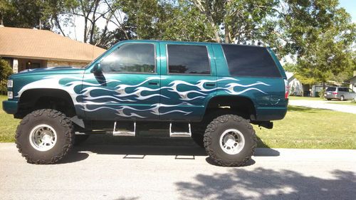1995 custom lifted tahoe dark green with hand painted grey flames tan leather
