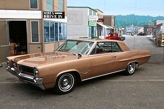 1964 pontiac grand prix. stunning automoblie. 8 lug wheels.