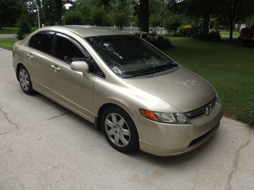 2007 honda, excellent condition, gold color, 5 speed, tinted glass.