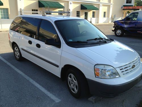 Ford freestar mini cargo van with ladder racks, shelves, bins and cab partition