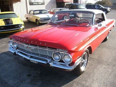 1961 chev impala  convertible 348 ci tri power 4 sped red/white top disc brakes.
