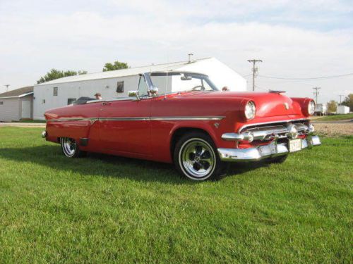 Classic 1954 ford crestline sunliner. convertible, red