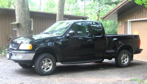 1998 ford black f-150 xlt extended cab short bed step side 4x4 pickup truck