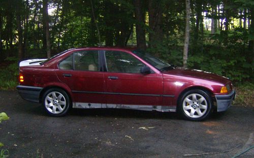 Red 1992 bmw 318i 4 door project car