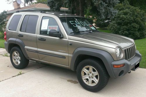 2004 jeep liberty tan. 4x4 p235 wide on/off road tires. mp3 w/ hd radio