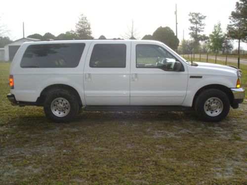 White exterior, blue leather interior with captain chairs