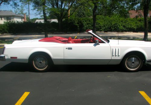 White exterior, new red leather interior, new black convertible roof; 460 engine