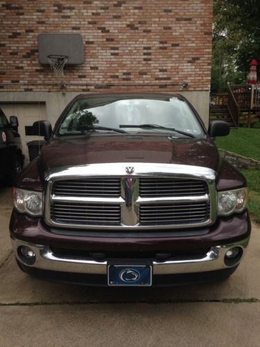 Maroon with soft tonneau cover quad cab in good shape