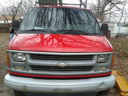 Red work van express 3500 with roof rack and cabinet space