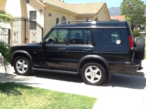 128k miles.  black with tan interior.  jump seats for a total of 7 passengers