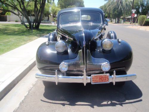 1939 black buick roadmaster touring sedan with dual sidemounts