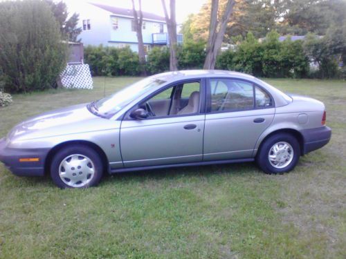 Silver 4 cylinder 5-speed, 4 door sedan, gray plush interior, a/c, great on gas