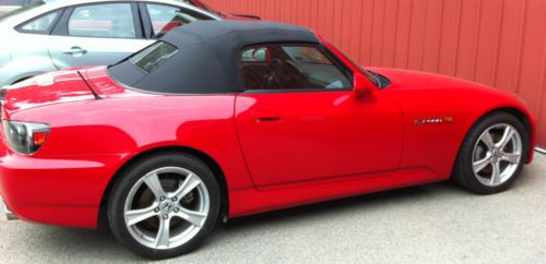 Red convertible sports car.  2009 in like new condition. low 18,530 mileage