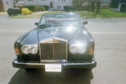 Black rolls royce corniche convertible with red interior and top