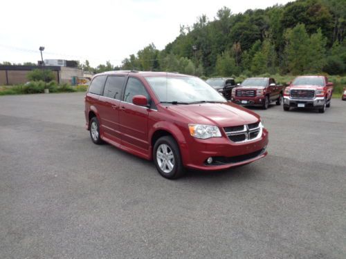 Handicap accessible van with power raise and lower ramp and suspension