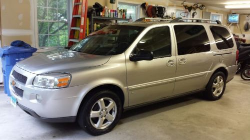 2008 silver chevrolet mini van with dvd player and 4 wireless headphones.