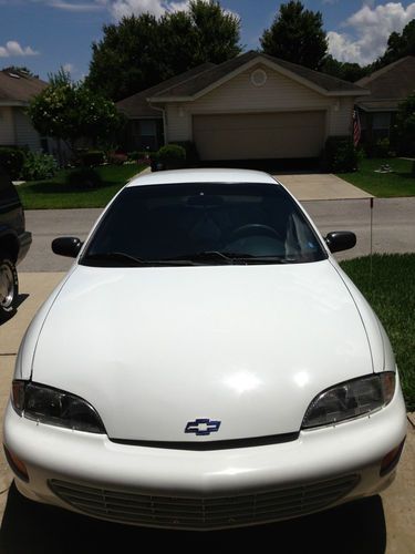 White, four door, automatic, low miles - 83k! great, inexpensive car.